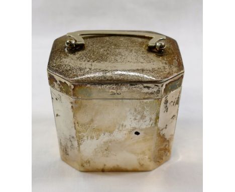 A late Victorian rectangular silver tea caddy of plain deign with chamfered corners and cushion topped hinged lid with swing 