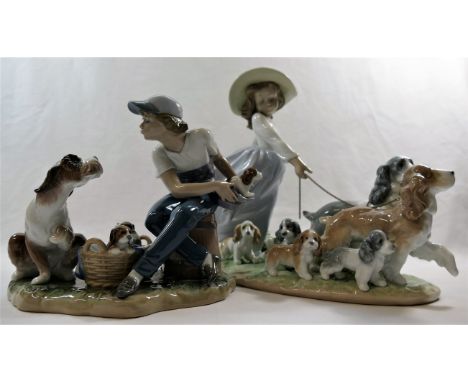 Two Lladro porcelain groups of figures with dogs and puppies, the tallest 24.5cm high CONDITION REPORT: Boy - Condition good.