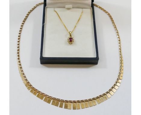 A small ruby and diamond oval cluster pendant, with receipt from 1989 for £165.00, stamped '375' and '9CT', 9mm long, on fine