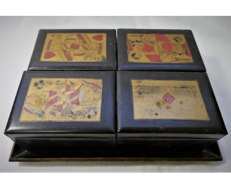 A 19th century bridge or gaming set comprised of four boxes each decorated in red and gilt with a suite of cards, containing 