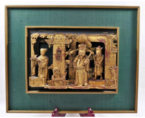 A framed Chinese carved gilt wood panel, of three figures within an interior, 16.5cm x 23.5cm, framedProvenance - Lots 45 - 4