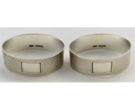 A pair of silver napkin rings with engine turned decoration, Birmingham 1959, 1.5cm wide, combined weight 0.94ozt, 29.2g COND