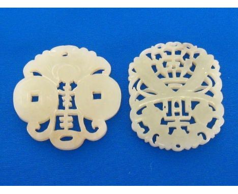 Two Chinese white jade openwork plaques, one circular plaque finely carved and pierced with a bat, coins and “shou” character