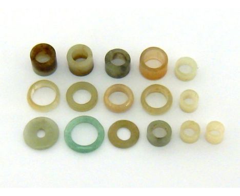 A group of Chinese carvings jade and jadeite attachment rings, 19th/20th century. 