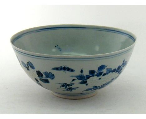 A Chinese blue and white bowl  with underglaze carving of flowers at the centre, a landscape within the bowl. Kangxi period ,