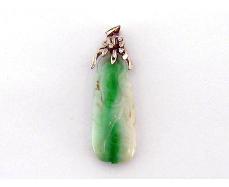 An Art Deco jade and diamond pendant, the oblong jade carved in the round with a fluid foliate design, the white metal and br