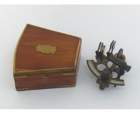 A reproduction brass sextant in brass bound shaped hardwood box. 