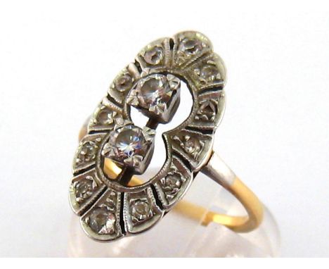 An Art Deco diamond plaque ring, the open work navette shaped bezel set to the centre with two box set brilliant cuts totalli