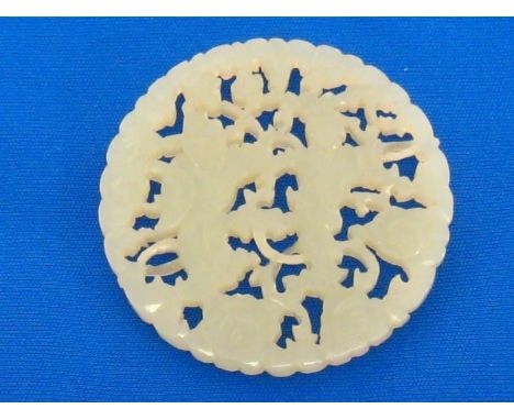 A Chinese white jade openwork circular plaque, the plaque finely carved and pierced on both sides with two boys playing among