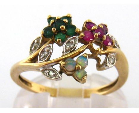 A diamond and gem set ring, the giardinetto style bezel set overall with small rubies, emeralds, opals and single cut accents