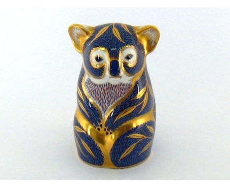 A Royal Crown Derby Koala in blue and gold. Gold button, red factory mark, numbered LII. 