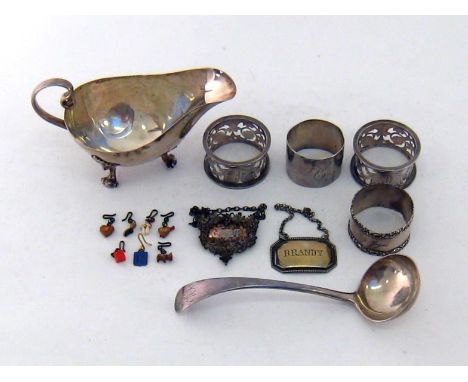 A silver sauceboat on 3 leaf & scroll feet by James Dixon & Sons, Sheffield, 1911; a pair of foliate-pierced napkin rings, Bi