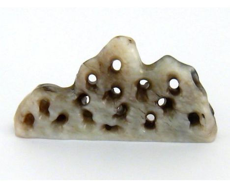 A Chinese grey jade brush rest, finely carved and pierced as a mountain range, possibly Ming dynasty, 10cm long * 5.6cm high 