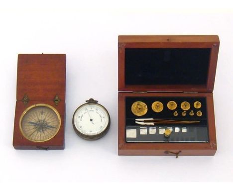 A 19th century gilt brass pocket barometer, a mahogany cased compass and a mahogany cased set of precision balance weights fr