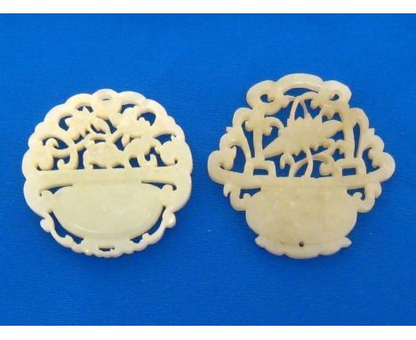 Two Chinese openwork white jade plaques, jades finely carved and pierced in the form of a floral display basket on each side.