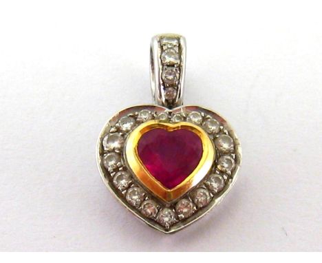 A ruby and diamond heart pendant, the central heart cut stone approx. 0.60 carat, rub over set in a surround of small brillia