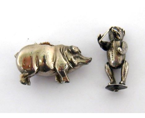 A white metal muzzled performing bear pin cushion, the bear standing holding a stick, Registered Number 537681, by HV Pithey 