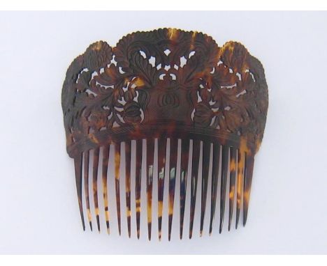 A large vintage tortoiseshell hair comb hand carved and pierced with foliage and flowers. 19x18cm. 
