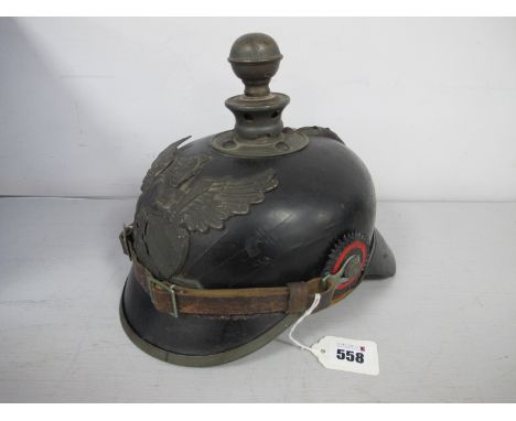 A WWI German Prussian Kugelhelm, with Baden helmet plate to centre, helmet is complete with pair of cockades and leather chin