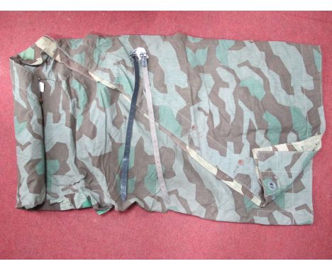 A WWII German Army Heer Zeltbahn, in splinter camouflage with leather straps marked Eckhardt Heinz on one strap. 