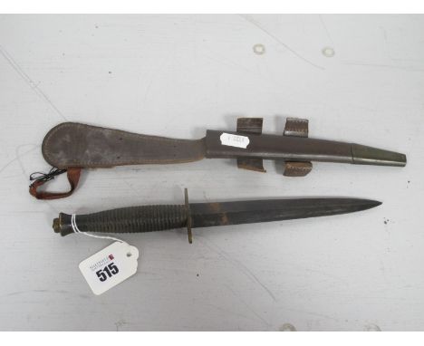 A British Army Fairbairn Sykes Commando Style fighting Knife, with leather scabbard. (Buyer to fully satisfy themselves regar