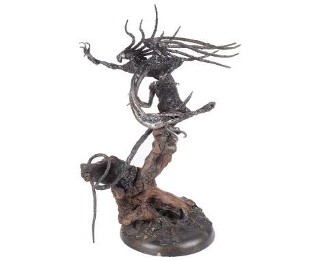 A Composite Dragon Sculpture:Depicting a tree trunk surmounted by a dragon with sinuous features, H 50 cm