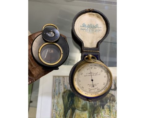 A 19th century cased pocket barometer together with a compass enclosed in a leather case