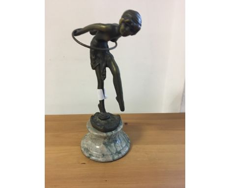 An Art Deco-style bronze woman and hoop