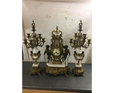 A large brass clock garniture