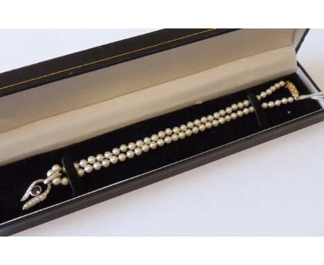 An 18 carat white gold sapphire and diamond pendant together with a pearl choker Necklace with gold clasp 