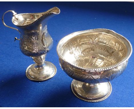 A 19th century helmet-shaped hallmarked silver Cream Jug together with matching circular Sugar on pedestal base, each piece d