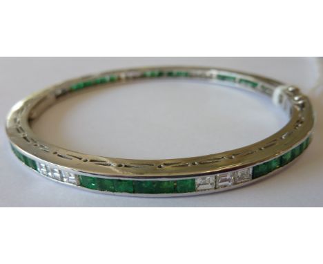 An 18 carat white gold Bracelet/Bangle set with princess cut emeralds and diamonds, (24 diamonds, 48 emeralds)