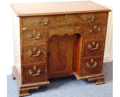 An 18th Century mahogany knee-hole Desk, the moulded top above a single full width drawer and a shaped flush drawer below abo