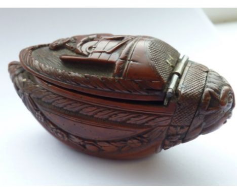 A late 18th Century boat shaped coquilla nut Snuff Box, (possibly French Napoleonic War period), the hinged lid extremely fin