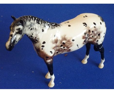 A 20th century Beswick, England "Appaloosa Stallion" standing four-square, 20cm high 