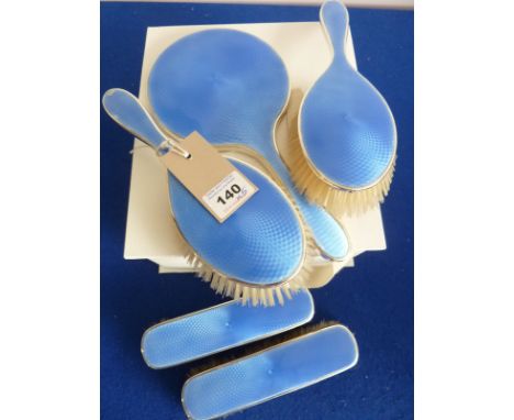 A five piece ladies hallmarked silver and blue enamel Dressing Table Set comprising two Clothes Brushes, two Hair Brushes and