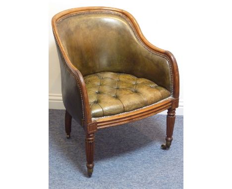 A 19th Century mahogany framed and green leather button down upholstered Bergere style Chair raised on turned tapering reeded