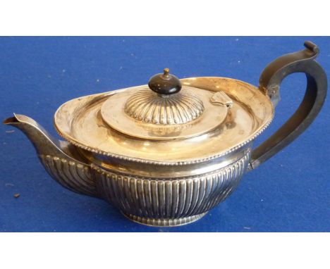 A heavy late 19th century hallmarked silver Teapot, the oval section top above a gadrooned lip and reeded lower body, with ca