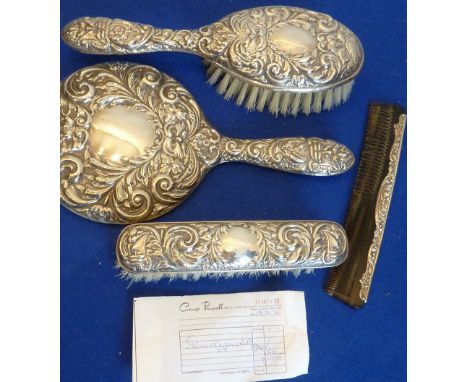 A silver four piece Dressing Table Set (probably unused) consisting of a Hand Mirror, Hair Brush, Clothes Brush and Comb, (co