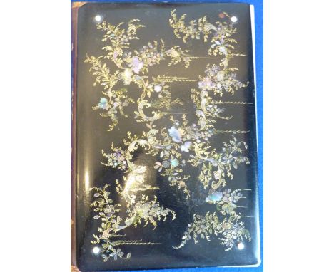 A 19th century Victorian era papier-mâché  Book Cover, the black lacquer decorated with mother of pearl and gilded floral spr
