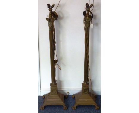 ADDED LOT    A pair of heavy brass Lamp Standards modelled as Corinthian columns, raised on square spreading bases terminatin