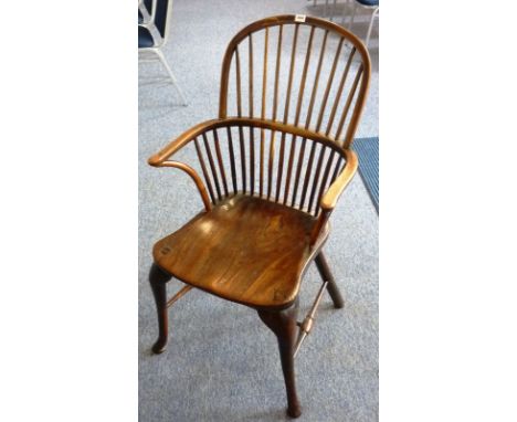 A late 18th/early 19th Century comb back Windsor Armchair (probably fruitwood bow), shaped elm seat and cabriole legs united 