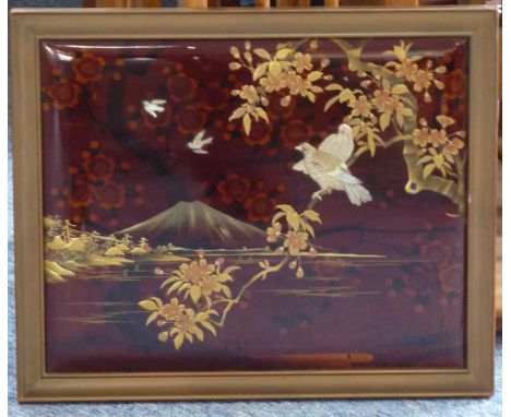 A Japanese Meiji period (1868-1912) red lacquer Panel decorated with two hand carved mother of pearl birds of prey seated on 