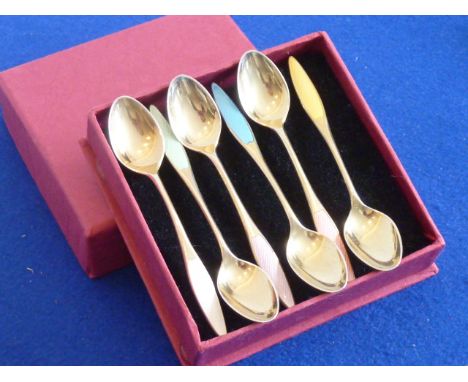 A set of six Danish silver gilt Coffee Spoons, each handle terminating in a different colour enamel, 9.5cm length, within a p