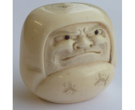 A 19th Century carved Japanese ivory Netsuke modelled as a flattened hooded head mask, 3cm high, two character signature to u