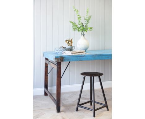 A unique vintage wooden dining table with a striking blue surface. Full of texture and rustic style, this table's legs can be