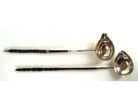 A George III silver toddy ladle
With whale bone twist handles, and applied beaded decoration, length 35.2cm, by George Basker
