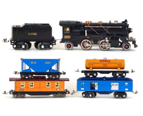 An Ives Lines 'O' gauge 2-4-2 locomotive
No 1663 with eight wheel twin bogey tender, together with a Lionel 1680 Shell tanker
