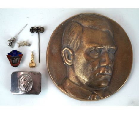 A cast brass bust of Adolph Hitler, 20th Century
Image of Hitler looking to his left, diameter 13cm, with two fixing holes ve