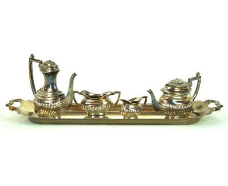 A miniature silver tea service
With embossed fluted decoration, comprising; coffee pot, tea pot, milk jug, sugar bowl and tra